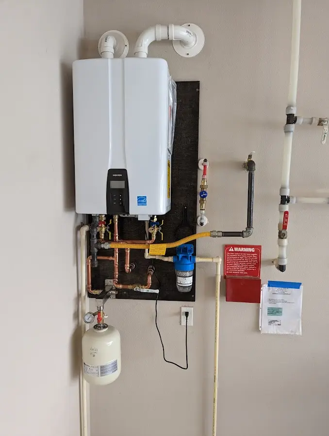 Professional plumber installing copper piping in a Huntingdon home